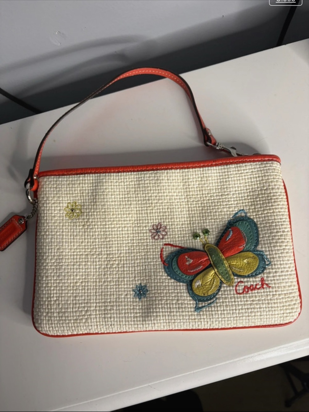 Coach Cream Wristlet with Multicolor Butterfly and Orange Trim